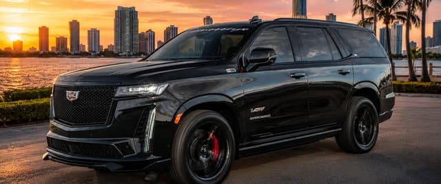 Black luxury SUV parked on waterfront promenade at sunset with city skyline and palm trees behind